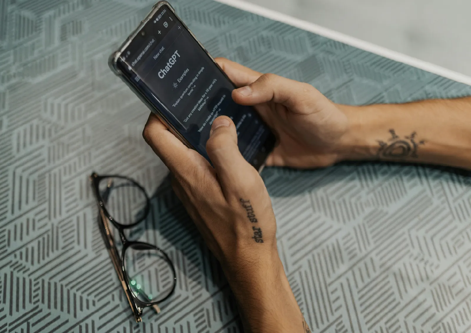 hands holding cell phone typing in AI prompts